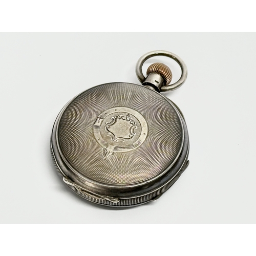 452 - A large Waltham silver pocket watch (1915) and an ornate late 19th century brass display case.