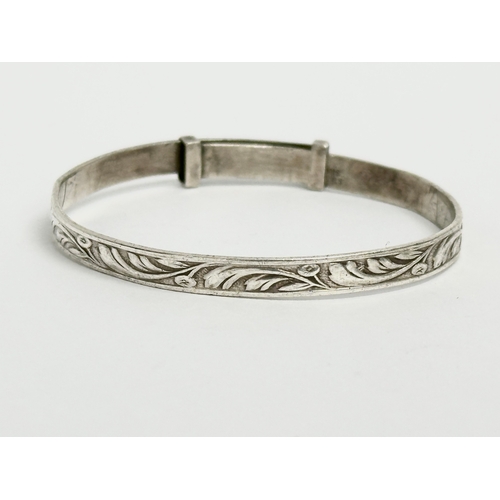 457 - 3 silver children’s bangles. Claddagh bangle measures 4.5x4cm. 14.64 grams total.