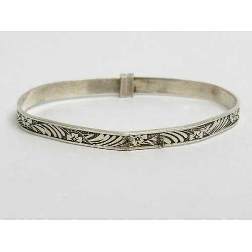 457 - 3 silver children’s bangles. Claddagh bangle measures 4.5x4cm. 14.64 grams total.