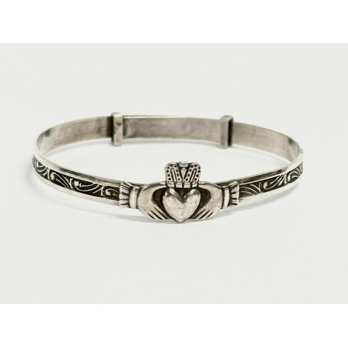 457 - 3 silver children’s bangles. Claddagh bangle measures 4.5x4cm. 14.64 grams total.