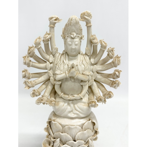 106 - A 20th century Chinese praying Guanyin figure with multiple arms on lotus leaves. 25cm