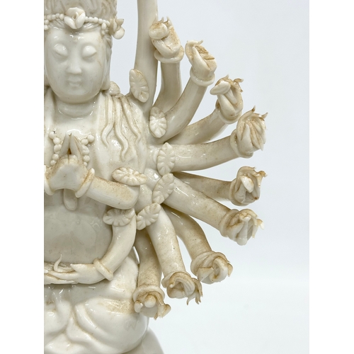 106 - A 20th century Chinese praying Guanyin figure with multiple arms on lotus leaves. 25cm