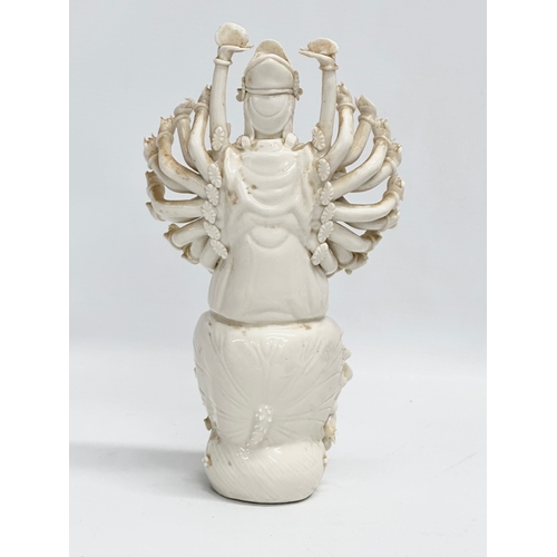 106 - A 20th century Chinese praying Guanyin figure with multiple arms on lotus leaves. 25cm