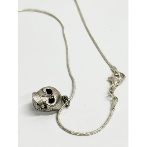 469 - A vintage silver Chinese style necklace with silver skull. 10.40 grams total. 26cm closed.