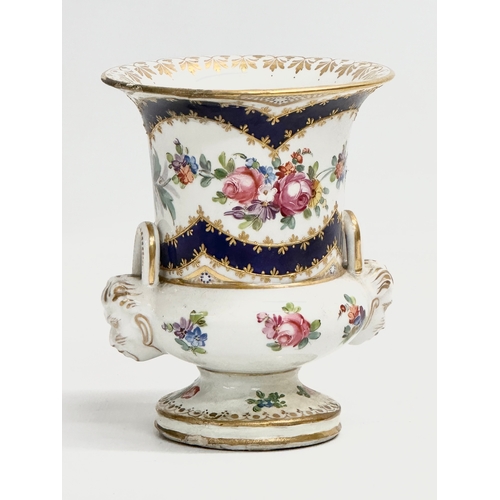 129 - A mid 18th century Sèvres hand painted porcelain pedestal vase with masked devil heads and embossed ... 
