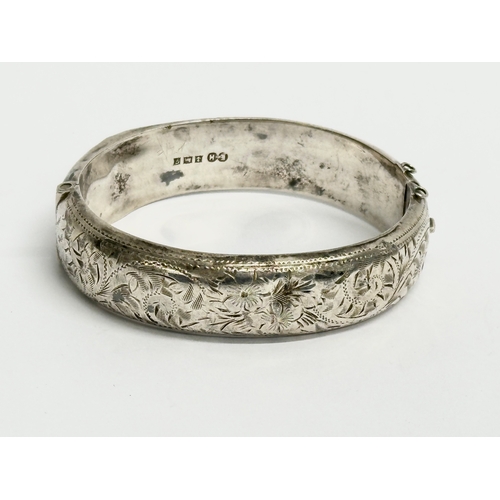 474 - A late 19th century Edwin Horton silver bangle. 7x6cm closed. 25.31 grams.