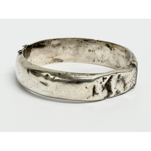 474 - A late 19th century Edwin Horton silver bangle. 7x6cm closed. 25.31 grams.