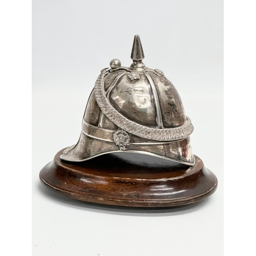 486 - A 19th century Irish silver inkwell in the form of a British Military helmet. 17x16cm