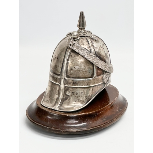 486 - A 19th century Irish silver inkwell in the form of a British Military helmet. 17x16cm