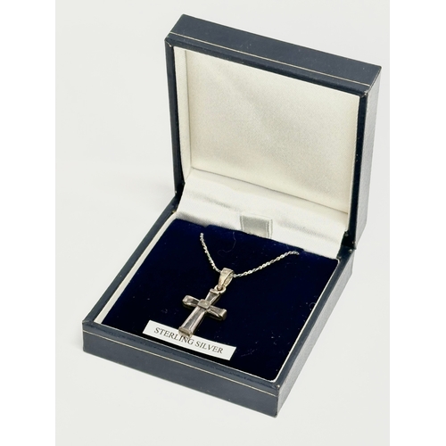 498 - A silver cross necklace with box.