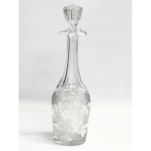 135 - A good quality early 20th century etched glass decanter with stopper. Decorated with leaves andgrape... 