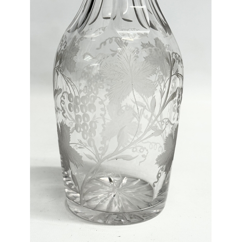 135 - A good quality early 20th century etched glass decanter with stopper. Decorated with leaves andgrape... 