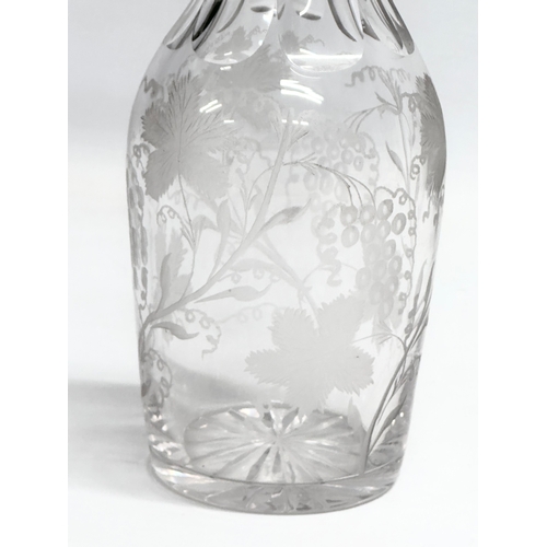 135 - A good quality early 20th century etched glass decanter with stopper. Decorated with leaves andgrape... 