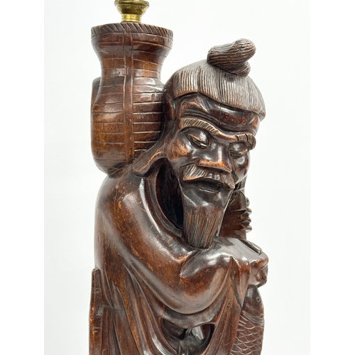 231 - A large early 20th century Chinese carved fisherman figure lamp. 59cm