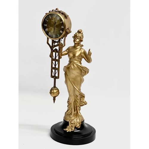 94 - A vintage gilt spelter Mystery Swing Clock. 35cm