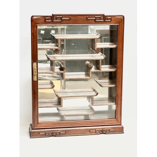 95 - A Chinese padauk wall hanging mirror back display cabinet with glazed door. 48x11x61cm
