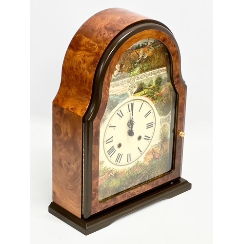 104 - A large Franklin Mint Burr Walnut mantle clock. Decorated with printed hunting scene. 27x11x37cm
