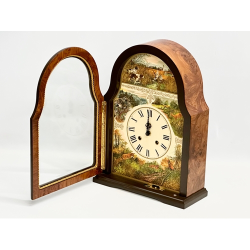 104 - A large Franklin Mint Burr Walnut mantle clock. Decorated with printed hunting scene. 27x11x37cm