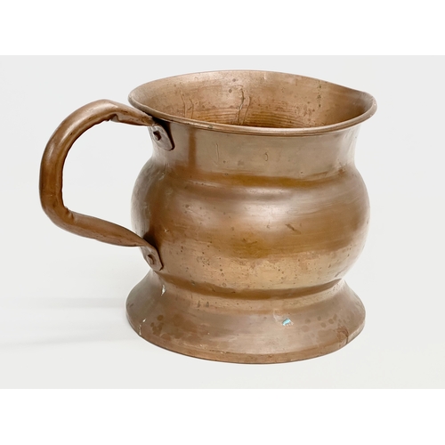 105 - A large mid/late 19th century French copper measuring jug. 27x37x24cm