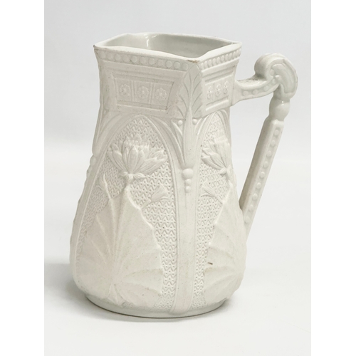 265 - 2 mid 19th century Copeland Parian Ware jugs. A Harvest Barrel jug 13x18cm.