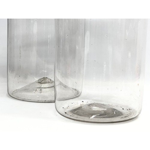 399A - A pair of large early 20th century glass jars. 26x53cm