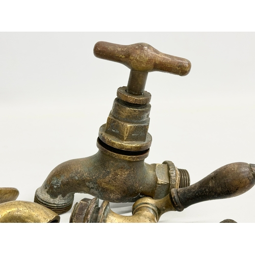 270 - A vintage Zodiac Rollover Corkscrew and 4 early 20th century brass taps