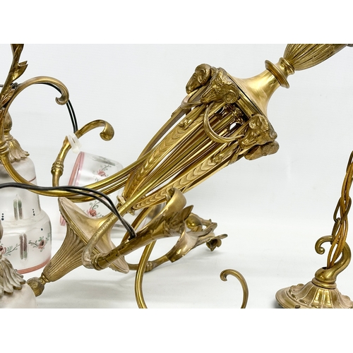100 - A large good quality vintage brass chandelier with etched glass shades and rams head masks. 100cm ha... 