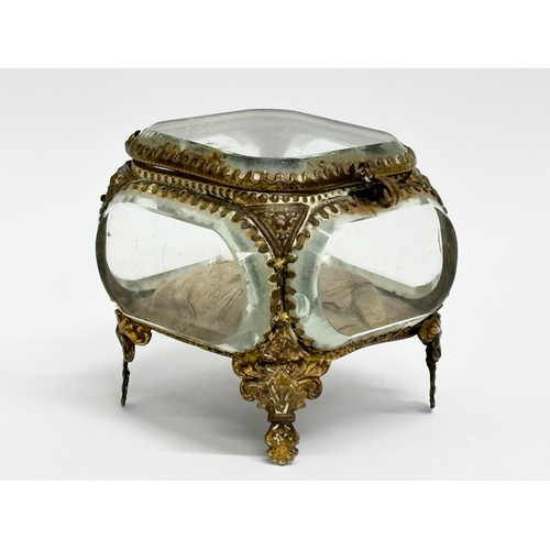 60D - A late 19th century ornate gilt brass pocket watch holder with 5 bevelled glass panels. 8x8x7cm