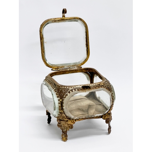 60D - A late 19th century ornate gilt brass pocket watch holder with 5 bevelled glass panels. 8x8x7cm