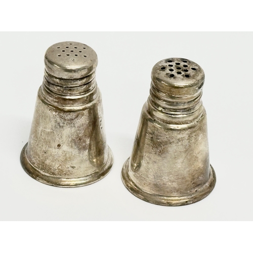 490 - A pair of sterling silver salt and pepper shakers. 35.71 grams. International Sterling.