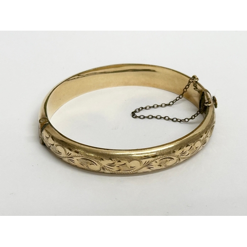 495 - A vintage rolled gold bangle with case.