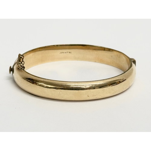 495 - A vintage rolled gold bangle with case.