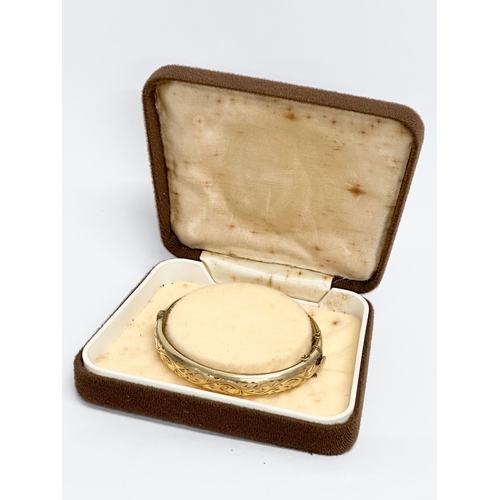 495 - A vintage rolled gold bangle with case.