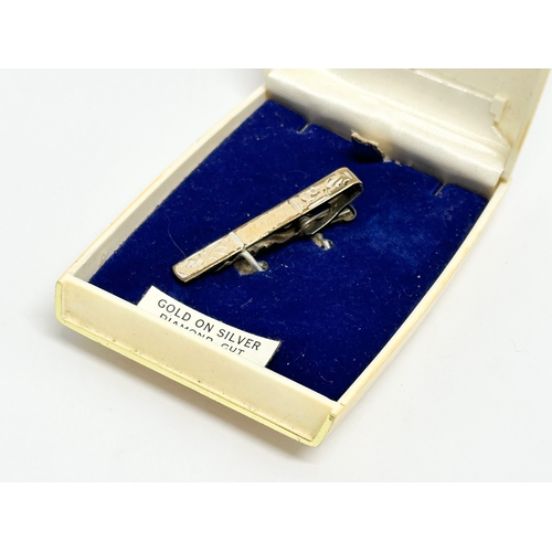 516 - A gold on silver diamond cut brooch with case.