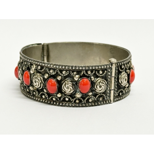 520 - An ornate Italian silver bangle. Stamped Alp, Italy. 6.5x6cm