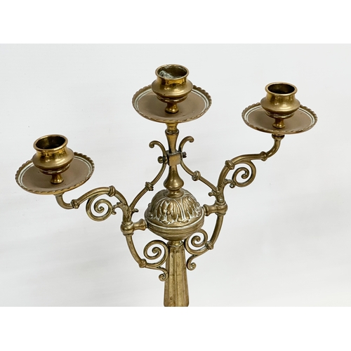 60E - A pair of large Victorian pierced brass candelabras. 29x16.5x38cm