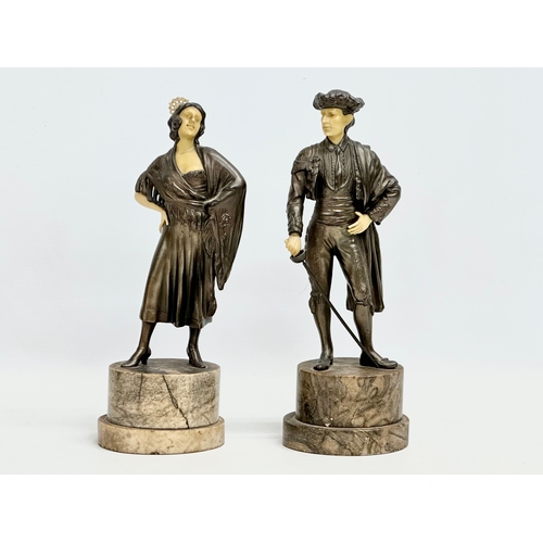 153C - A pair of 1930’s Art Deco spelter and faux ivory figures on marble bases. 26.5cm