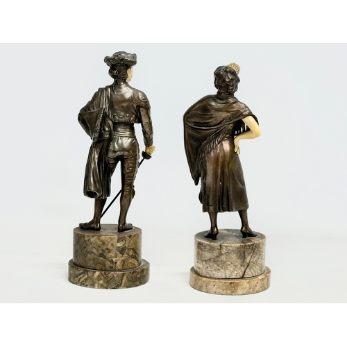 153C - A pair of 1930’s Art Deco spelter and faux ivory figures on marble bases. 26.5cm