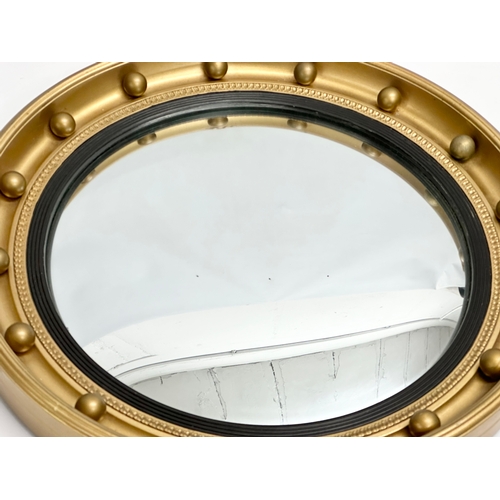 175D - A vintage Regency style gilt framed convex mirror. 47x70cm