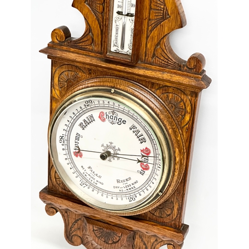 120 - A Victorian carved oak barometer. 28x84cm