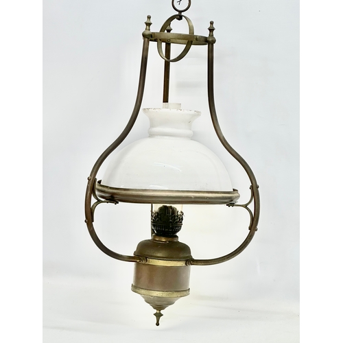 275G - An early 20th century hanging brass oil lamp with glass shade. 37x75cm