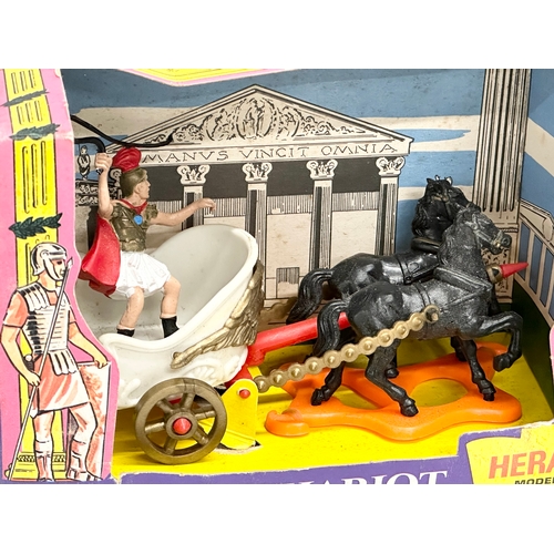 584 - A Britains Herald Models Roman Chariot with box. 19x9x13cm