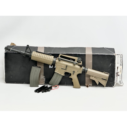 588 - An Umarex Elite Force electric assault rifle with box, pellets, tactical vest, carting case etc. rif... 