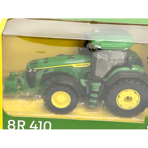 719 - A new Britains Prestige Collection John Deere 8R 410 tractor in box. 30x13x15cm