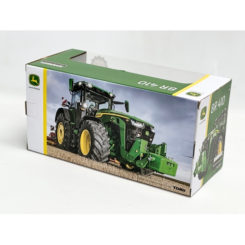 719 - A new Britains Prestige Collection John Deere 8R 410 tractor in box. 30x13x15cm