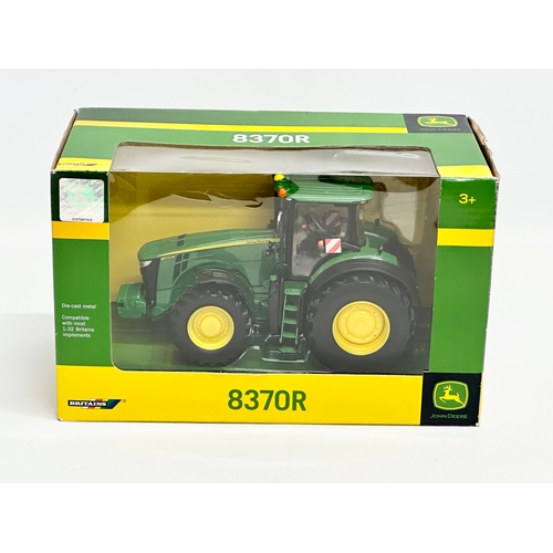 720 - A new Britains John Deere 8370R tractor in box. 25x13x15.5cm