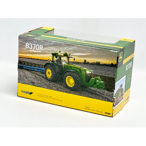 720 - A new Britains John Deere 8370R tractor in box. 25x13x15.5cm