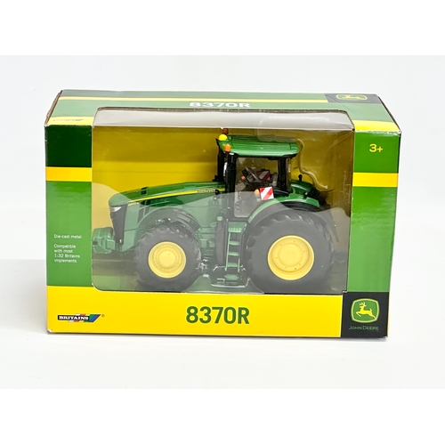 723 - A new Britains John Deere 8370R tractor in box. 25.5x13.5x15.5cm