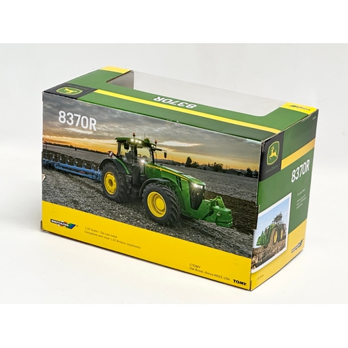 723 - A new Britains John Deere 8370R tractor in box. 25.5x13.5x15.5cm