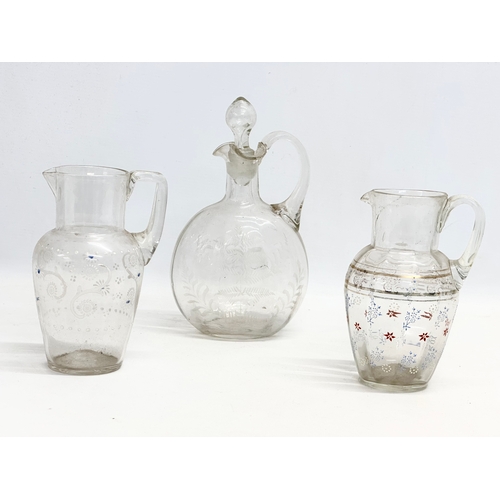 345G - 3 pieces of Victorian glassware. 2 Victorian embossed painted jugs 12x17cm. A Victorian etched glass... 